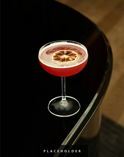 a glass with a drink on a table