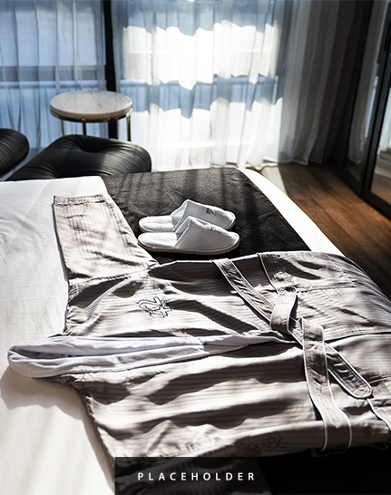 a robe and slippers on a bed