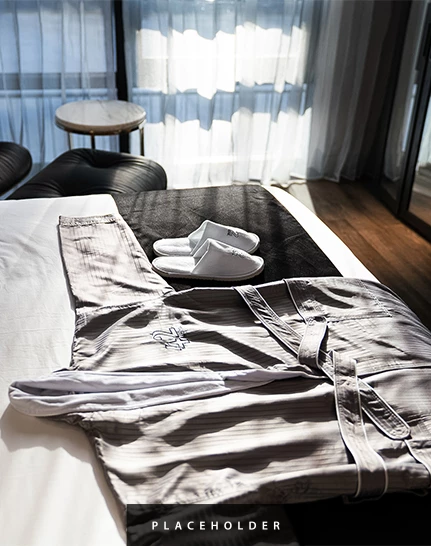 a robe and slippers on a bed