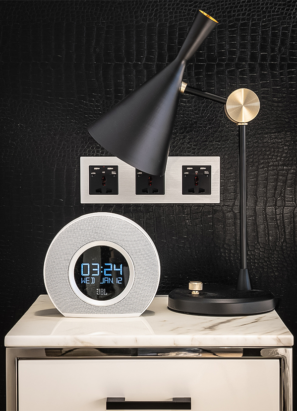 a alarm clock and a lamp on a table