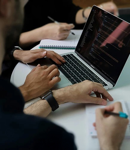 a group of people working on a laptop