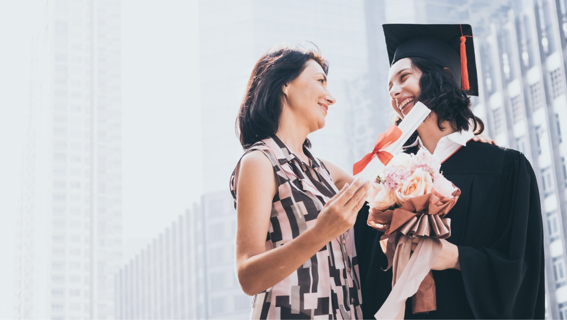 a woman holding a diploma and smiling