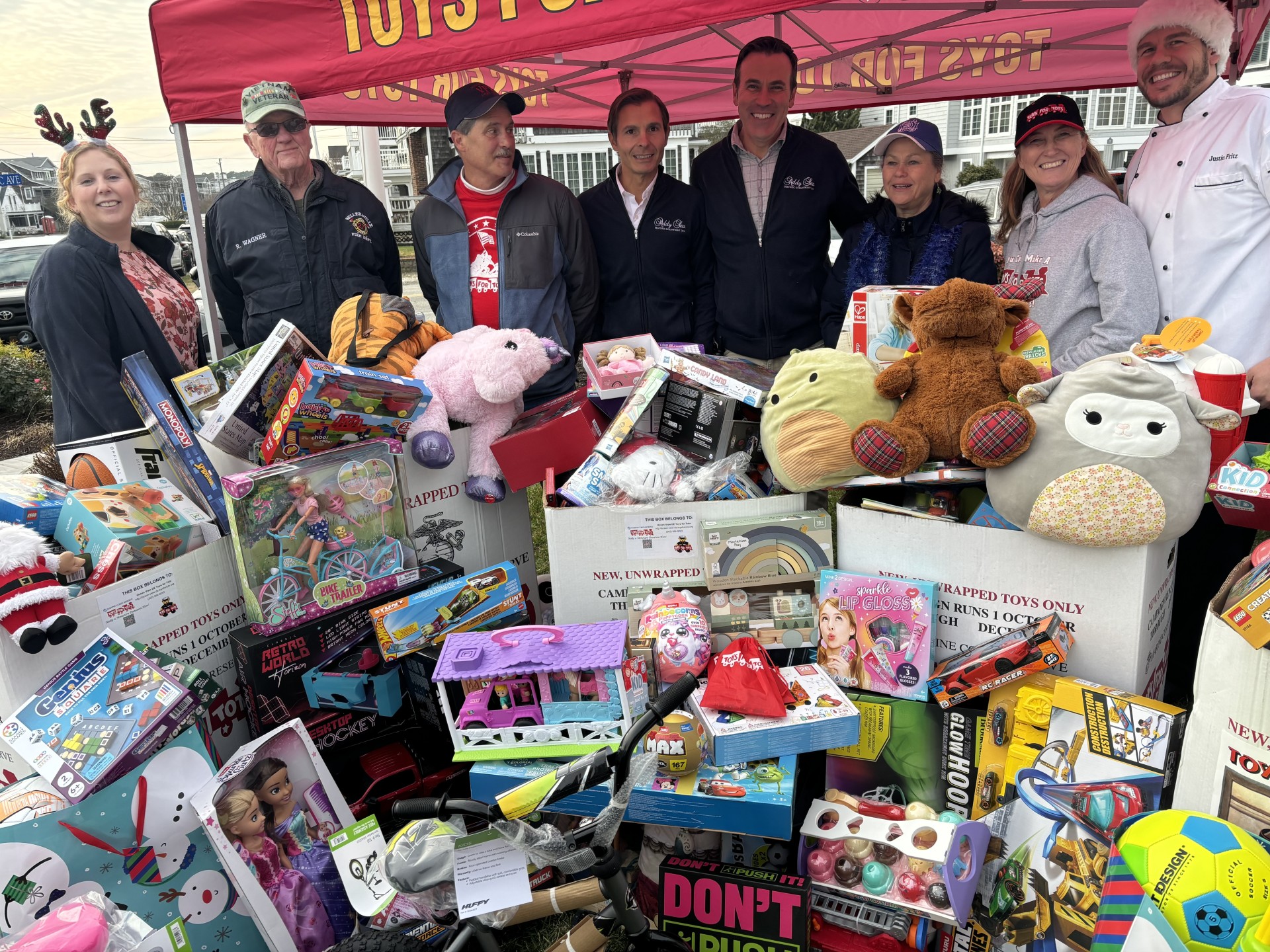 a group of people posing for a photo with toys