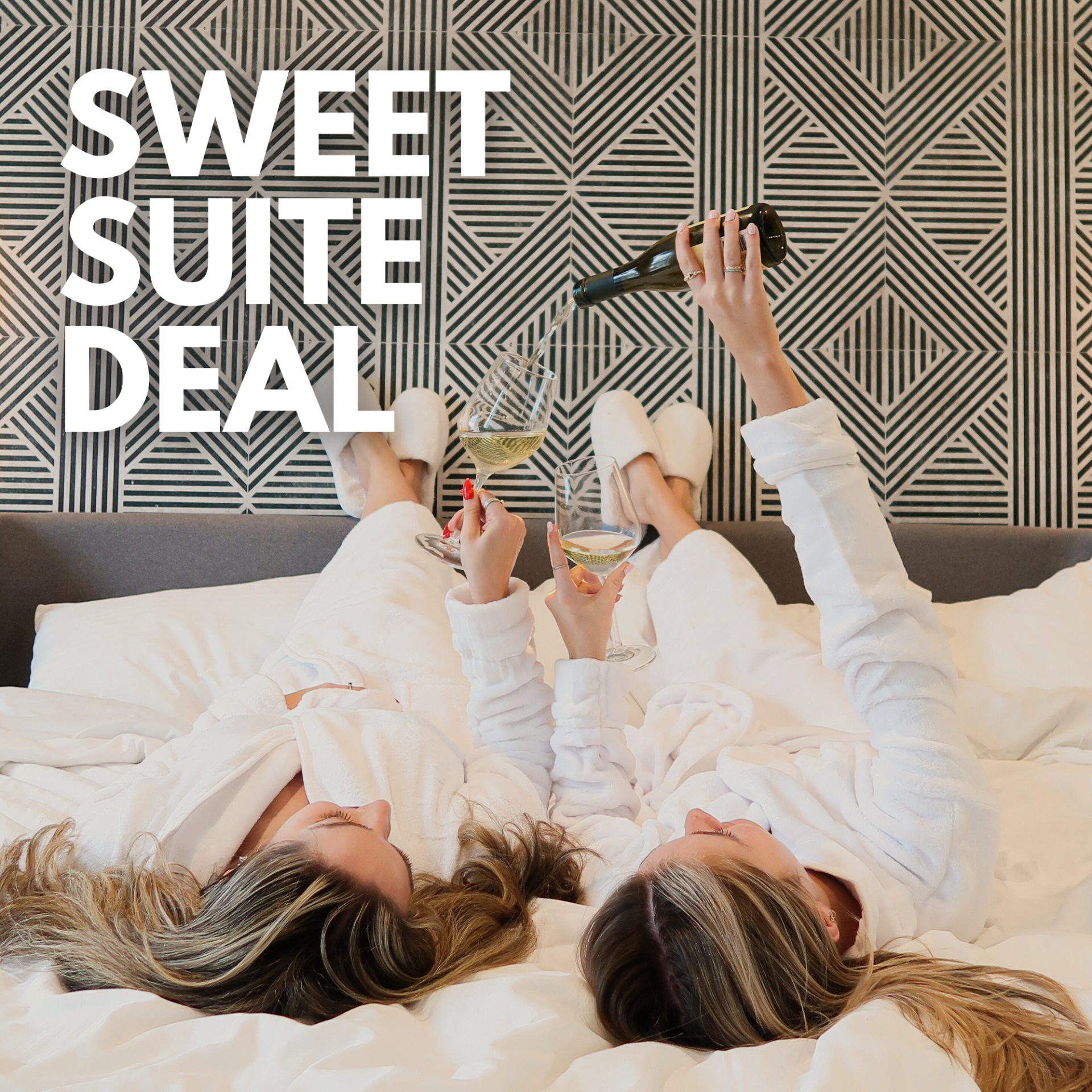 a couple of women lying on a bed