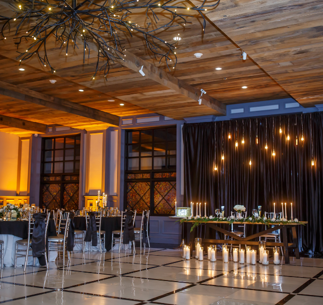 a room with a table with candles and chairs
