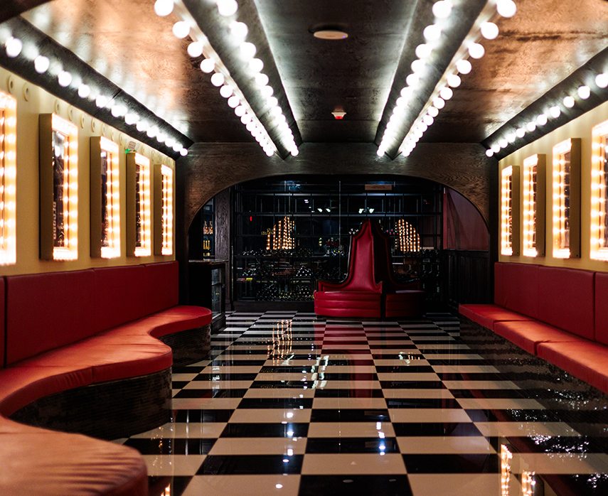 a room with a checkered floor and red benches