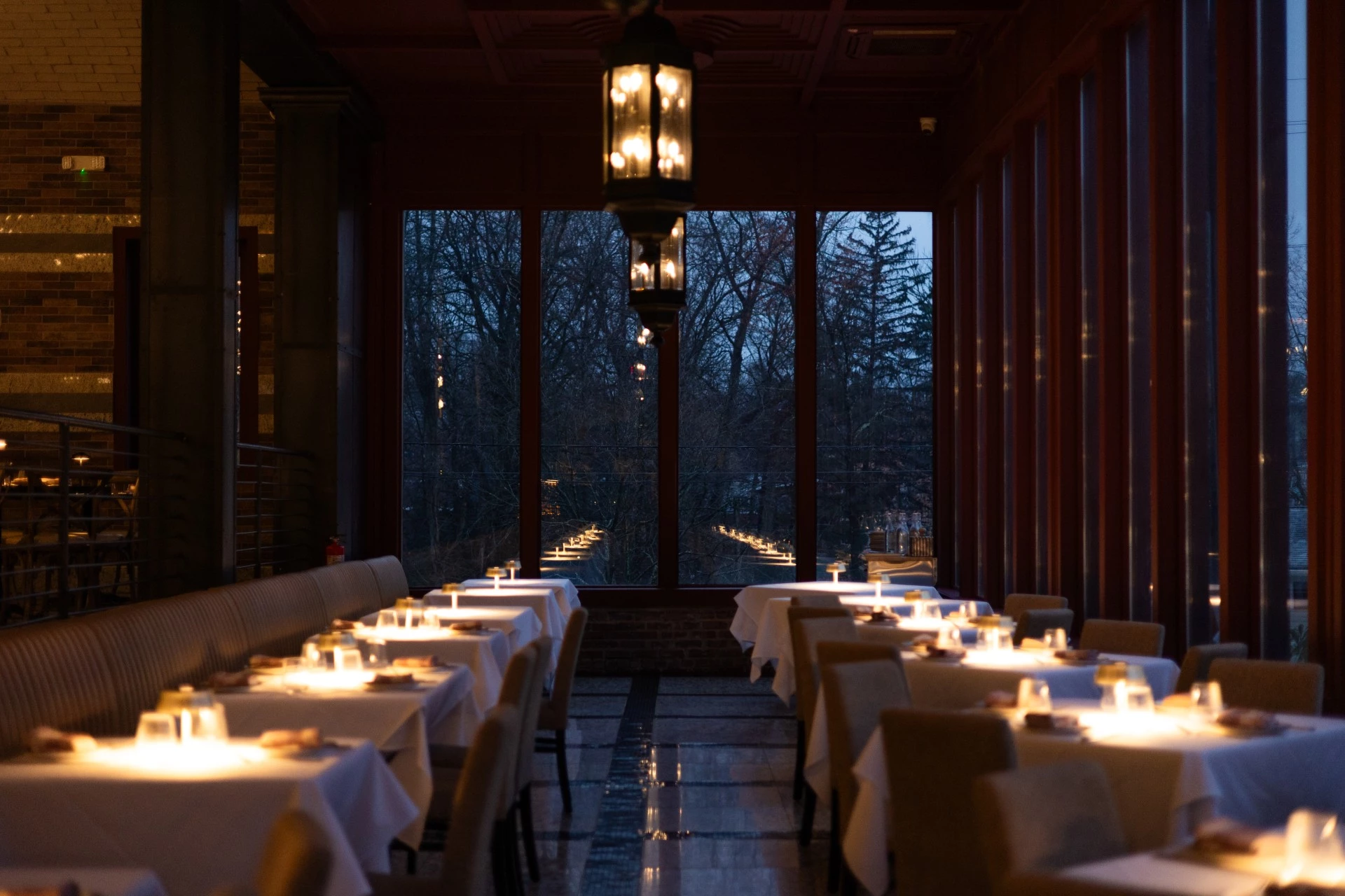 a room with tables and chairs with candles