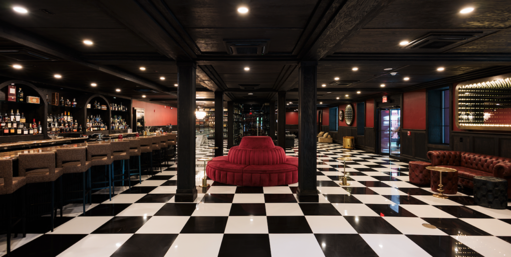 a room with a red couch and black and white checkered floor