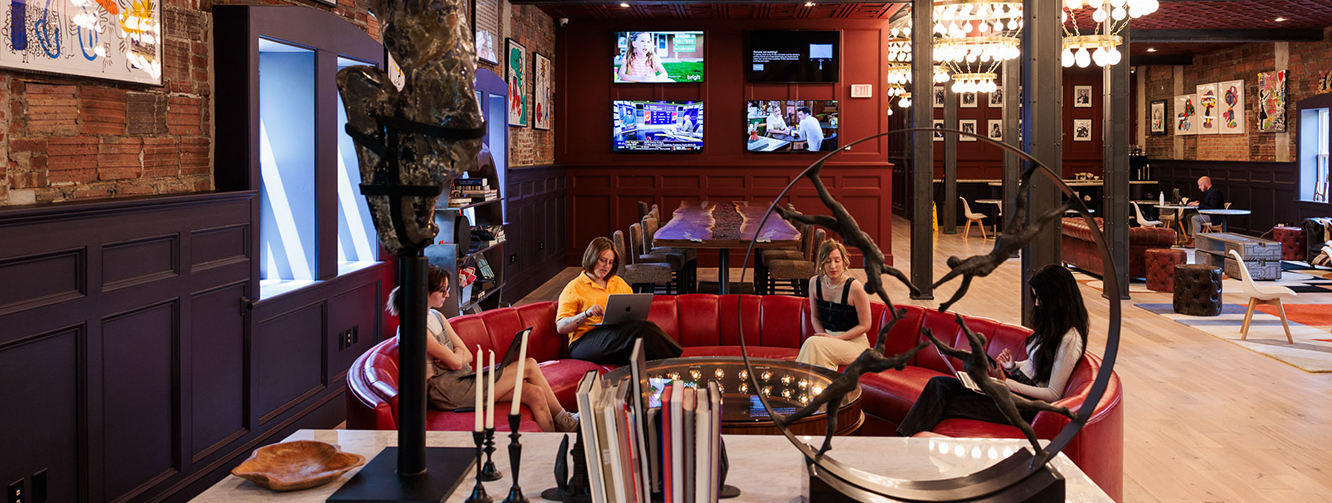 a group of people sitting on a red couch