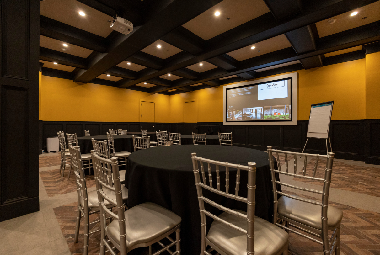 a room with a black table and chairs