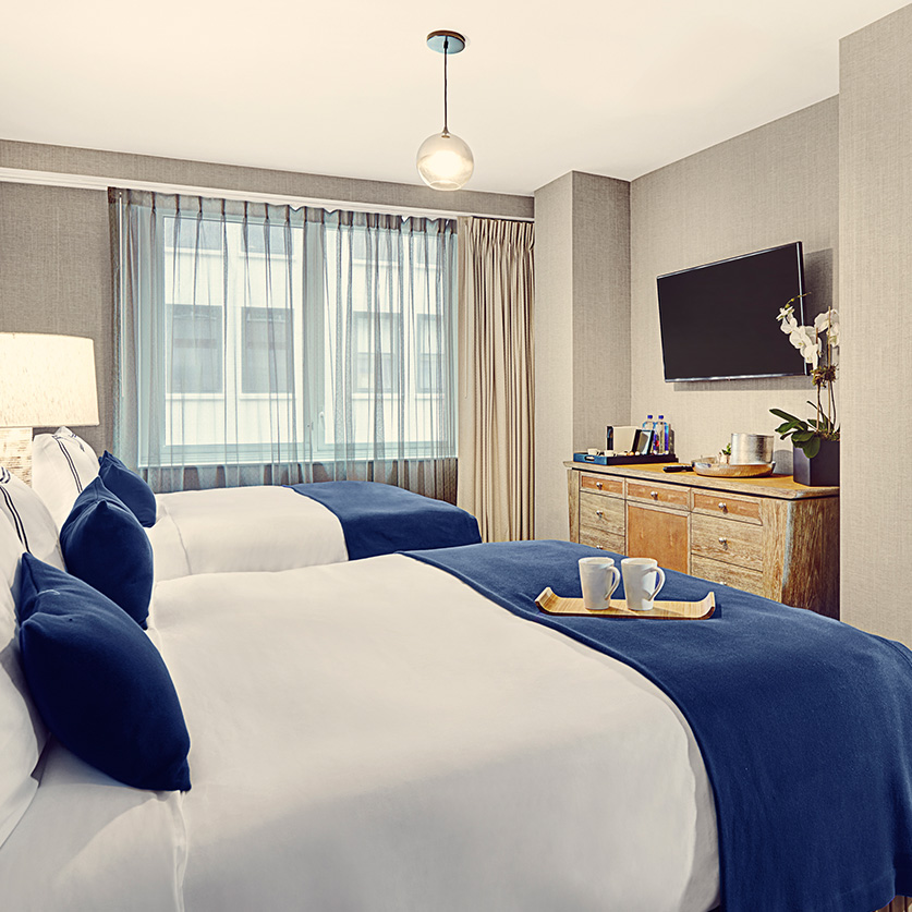 a room with two beds and a tv