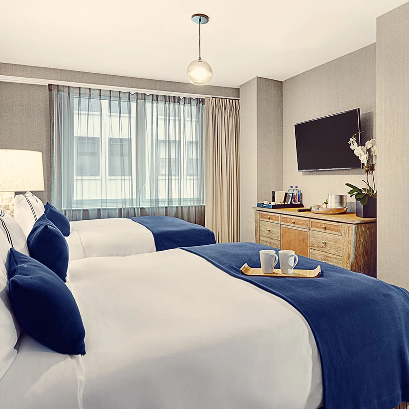 a room with two beds and a tv