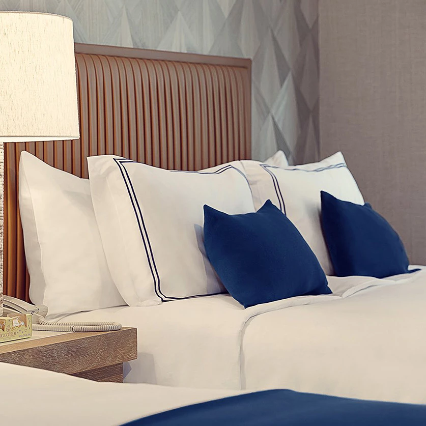 a bed with pillows and a lamp