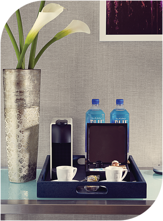 a tray with a coffee cup and a small device on it