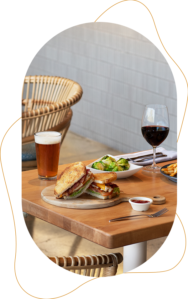 a sandwich and a glass of wine on a table