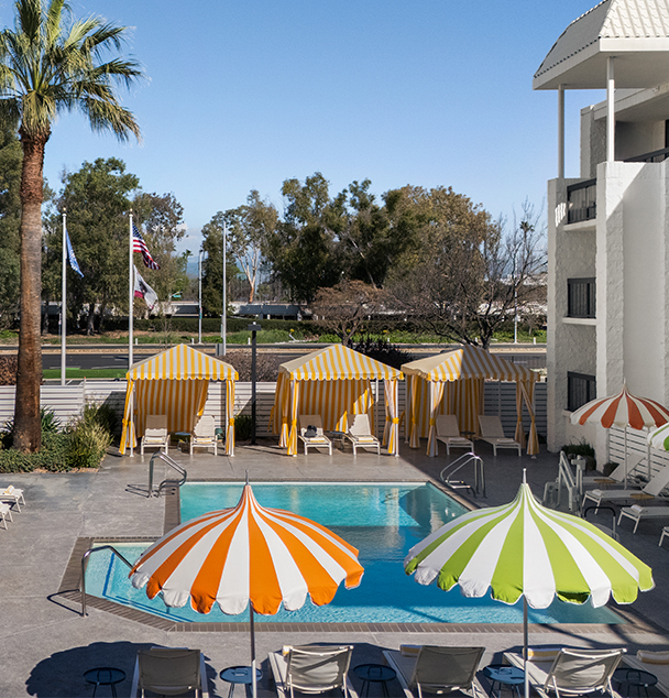 a pool with umbrellas and chairs