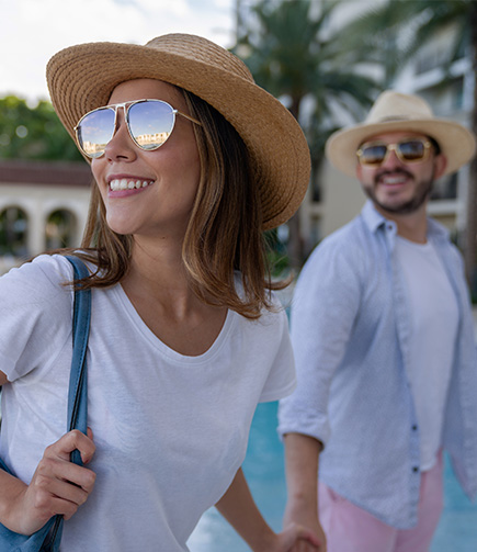 a woman wearing sunglasses and a hat