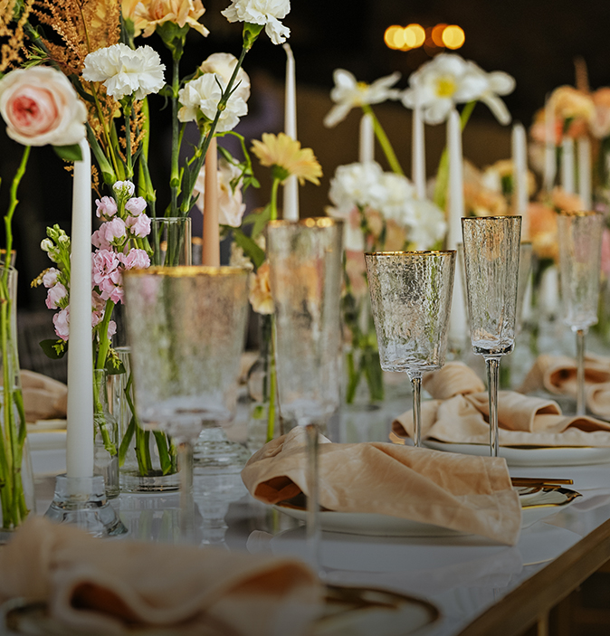a table with flowers and glasses