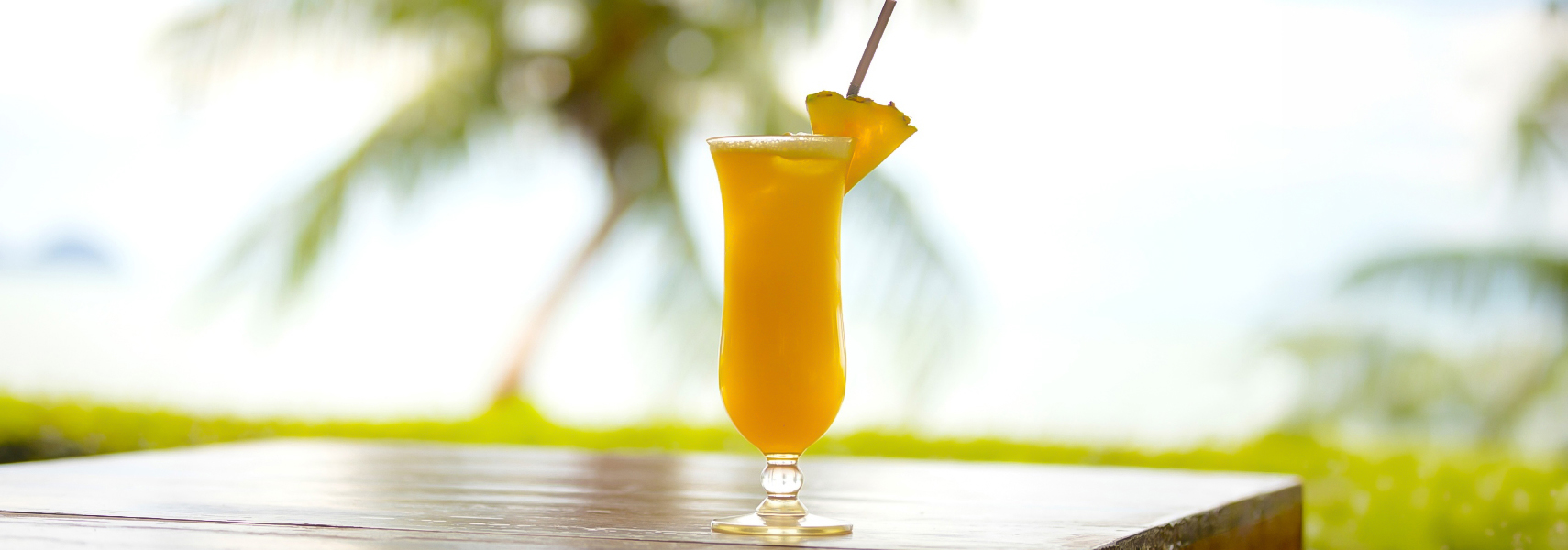 a glass with a drink and a straw
