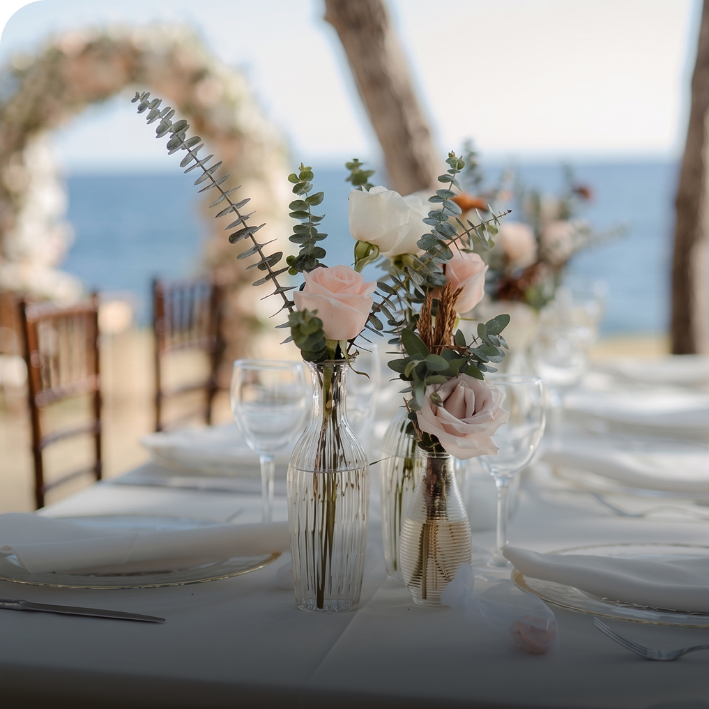 a table set with flowers and glasses