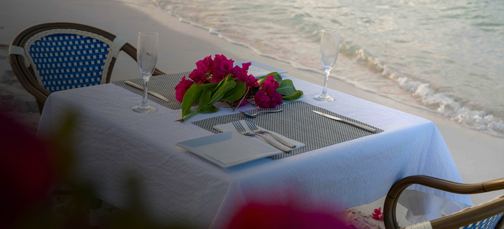 a table with flowers and glasses on it
