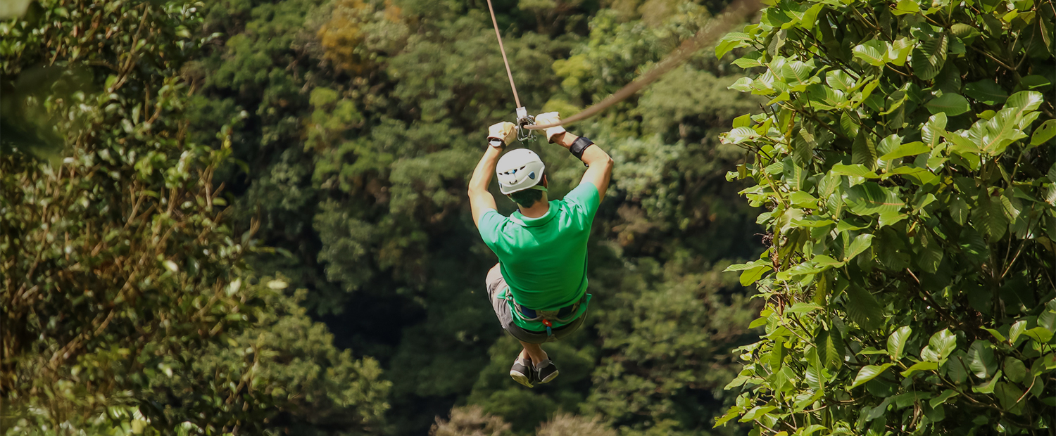 a man in a helmet zip line