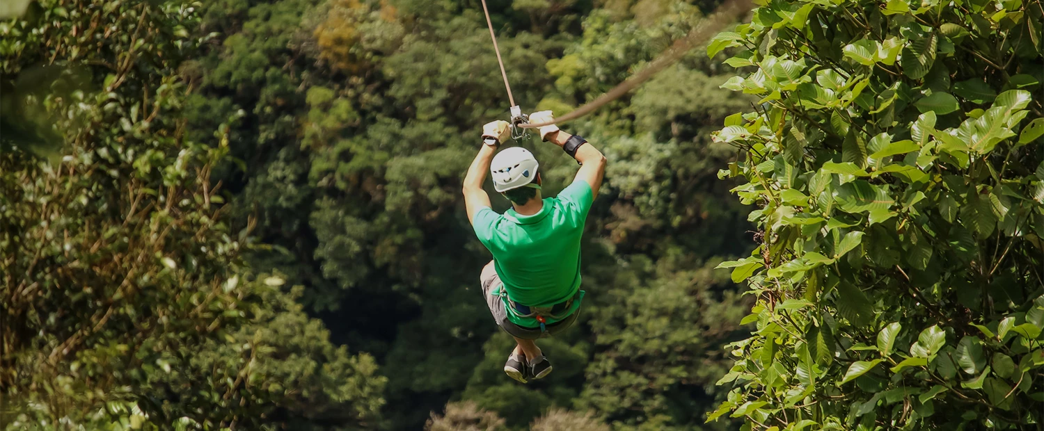a man in a helmet zip line