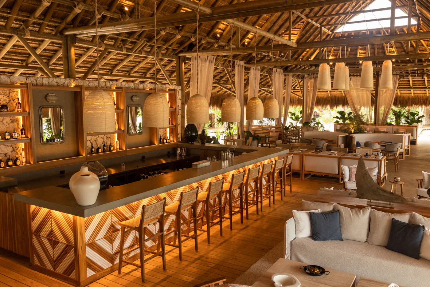 a room with a bar and chairs