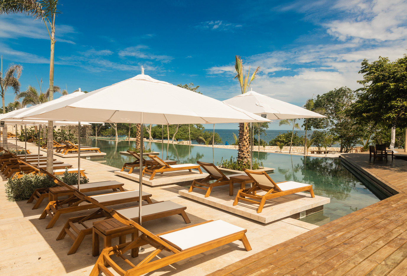 a pool with chairs and umbrellas