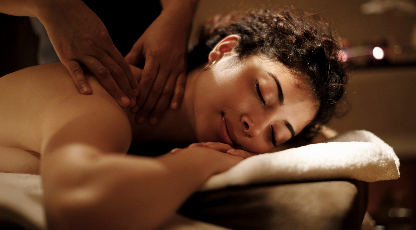 a woman lying down on a massage table