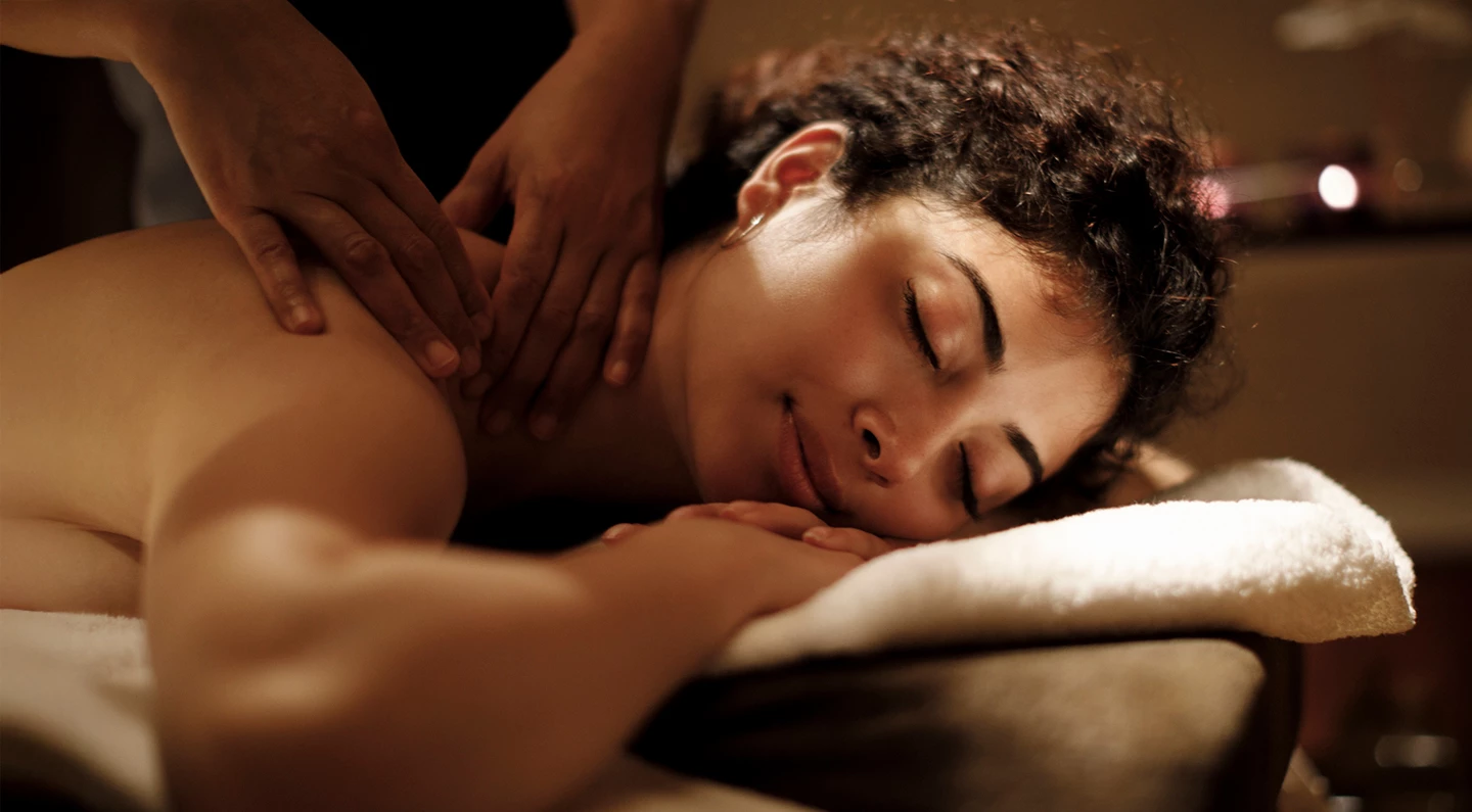a woman lying down on a massage table