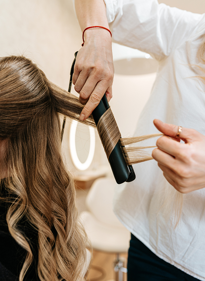 a woman curling her hair