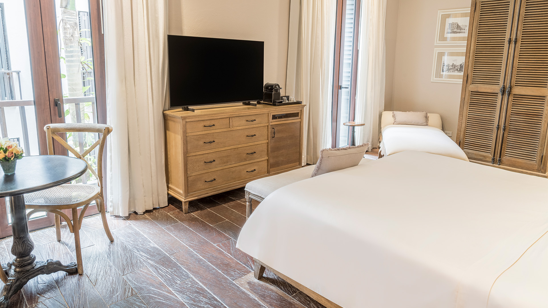 a bedroom with a television on a dresser
