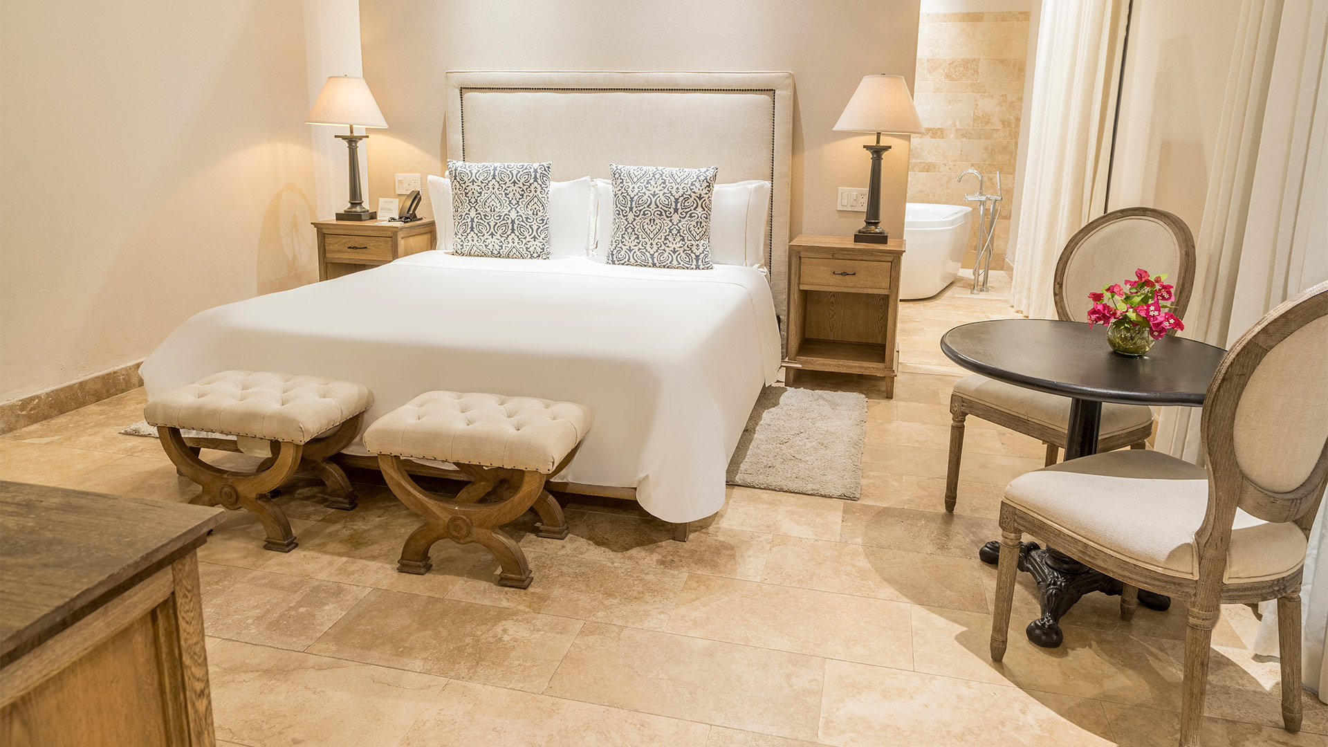a bedroom with a bed and a tub