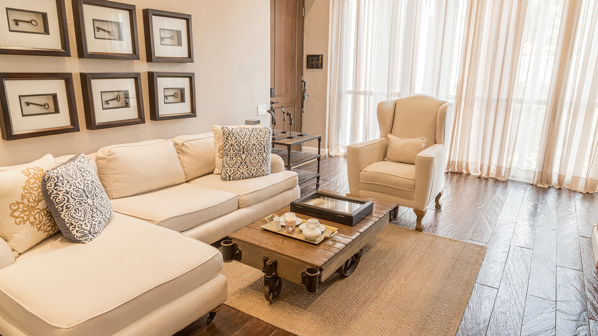 a living room with white couches and a coffee table