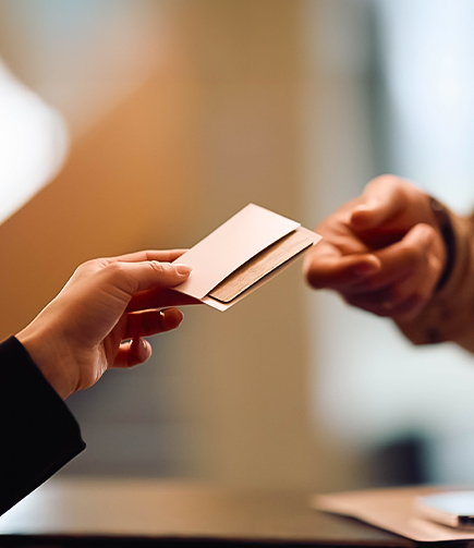 a person handing over a card to another person