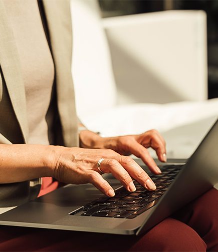 a woman typing on a laptop