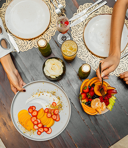 a person eating fruit on a plate