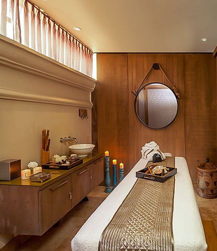 a room with a mirror and a bed