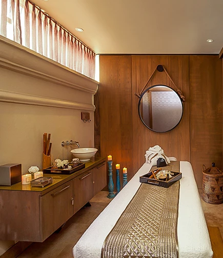 a room with a mirror and a bed