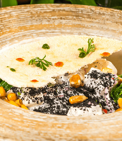 a bowl of food with a cracker on top