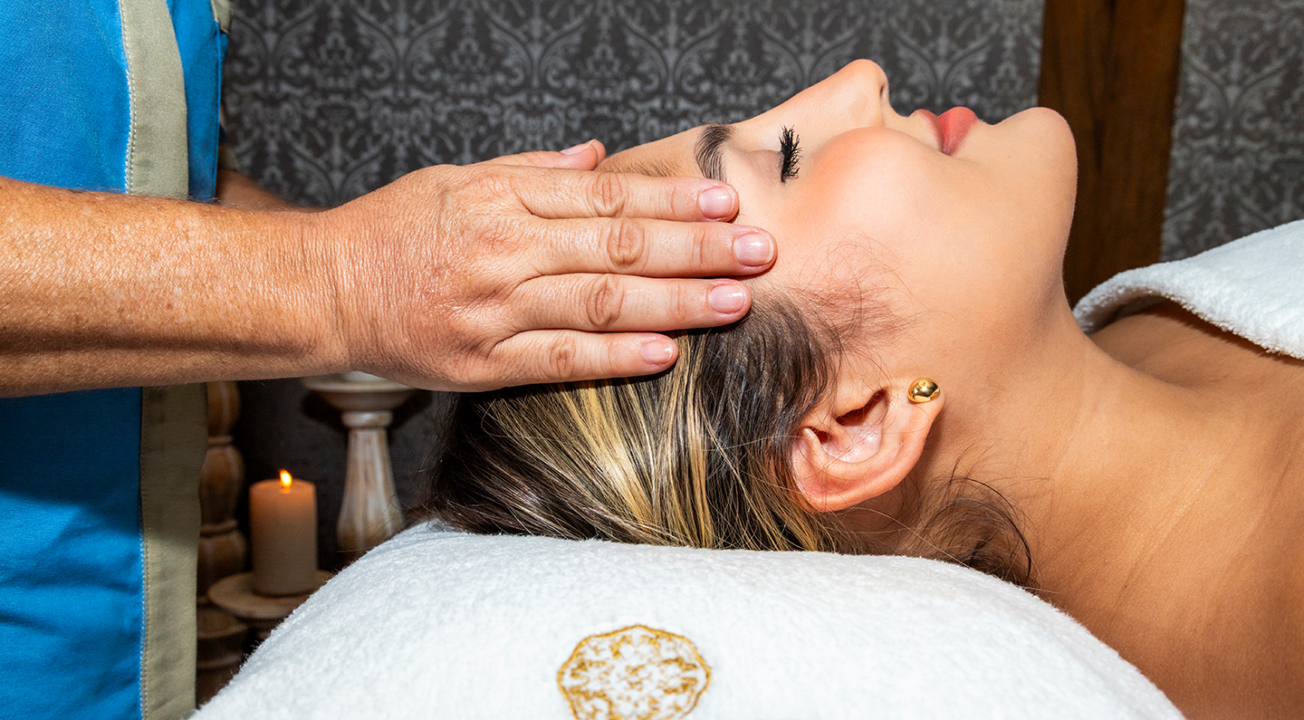 a woman receiving a head massage