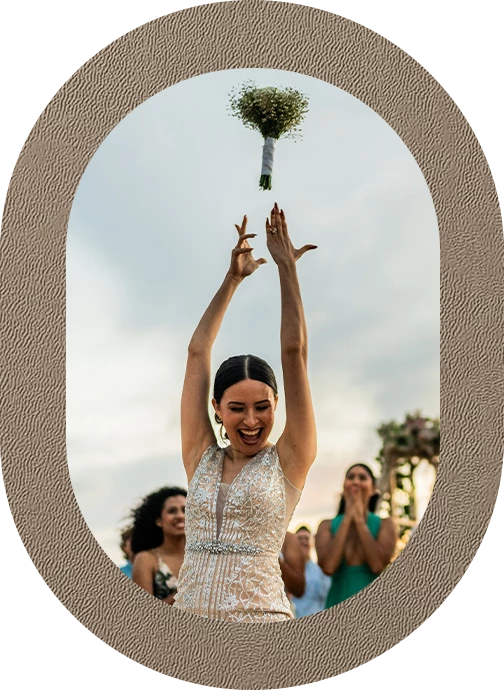 a woman throwing a bouquet of flowers