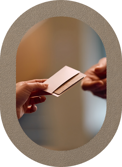 a person handing a piece of paper to another person