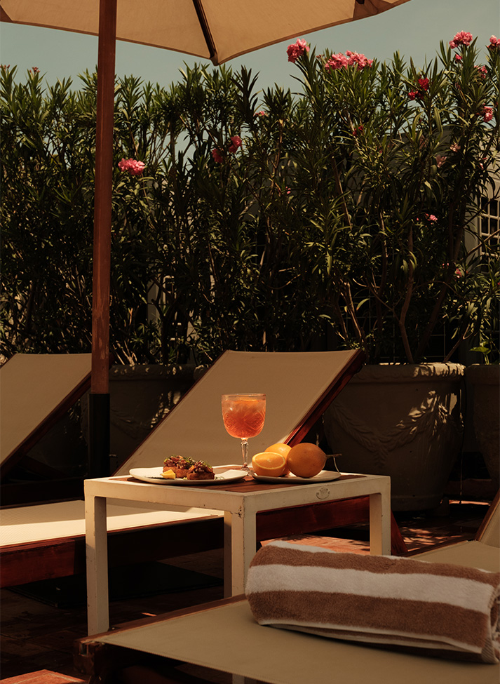 a table with food and drinks on it on a deck chair