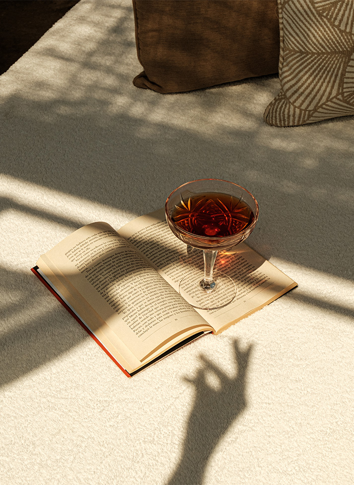 a glass of liquid on a book