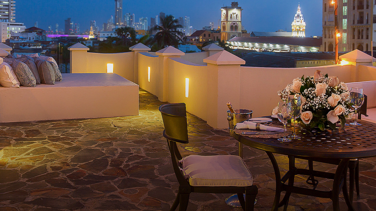 a table set up on a patio with a city in the background