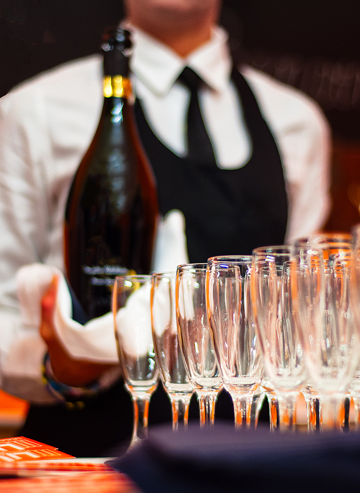 a person holding a bottle of champagne