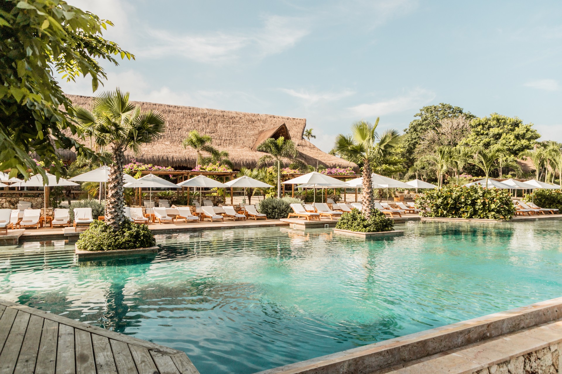 a pool with lounge chairs and umbrellas