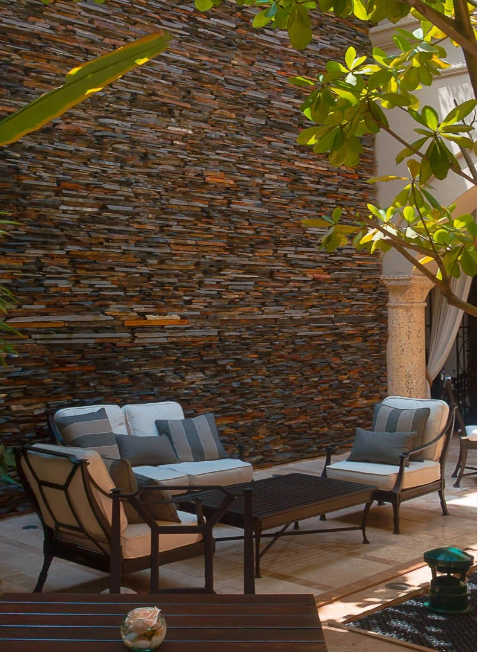 a patio with chairs and a table